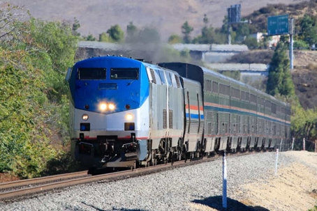 Train travels on the tracks during the day